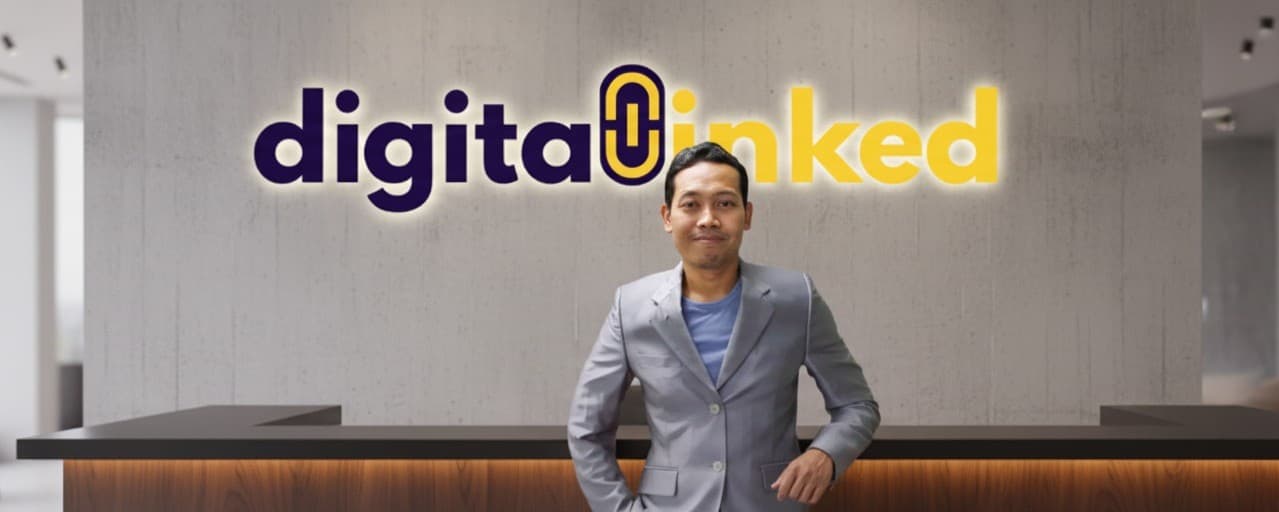 Digital Linked founder in the office with company signage